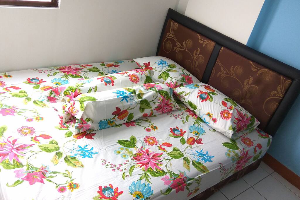 Queen sized bed on room 1