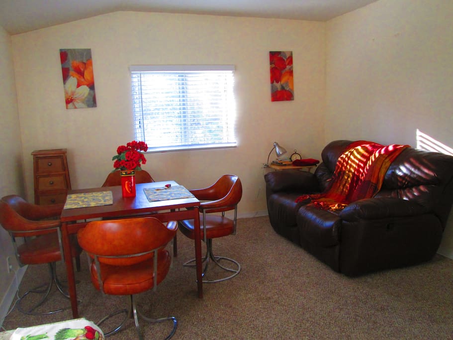 Comfortable dining area with love seat to curl on together. ..