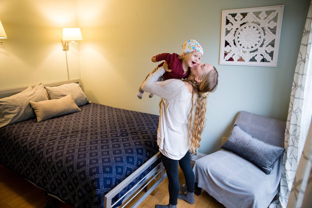 The Bukowski room has a queen bed, beautiful large windows and a closet with built in shelves and room to store luggage.