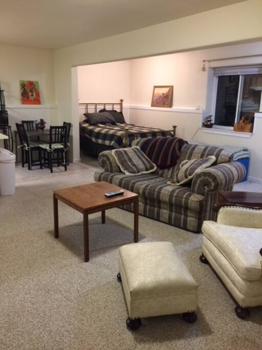 Living area with second bed, flat screen TV, office space with printer and Wi Fi