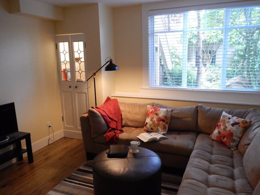 Living room with large window overlooking garden