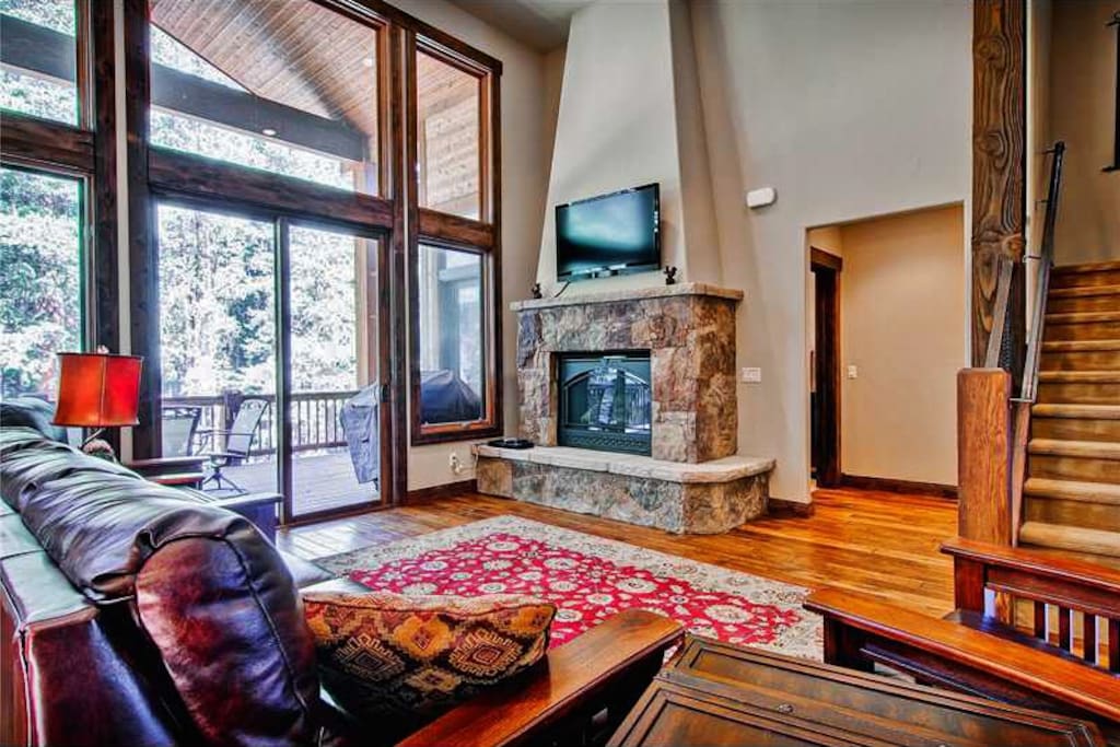 Cozy up in the inviting main floor living room next to the warmth of the fireplace.