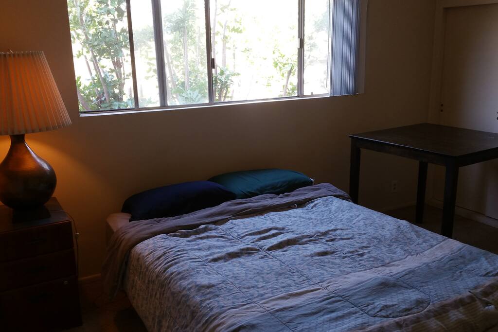 BEDROOM 1: Right next to the bathroom. Queen size bed with big windows!