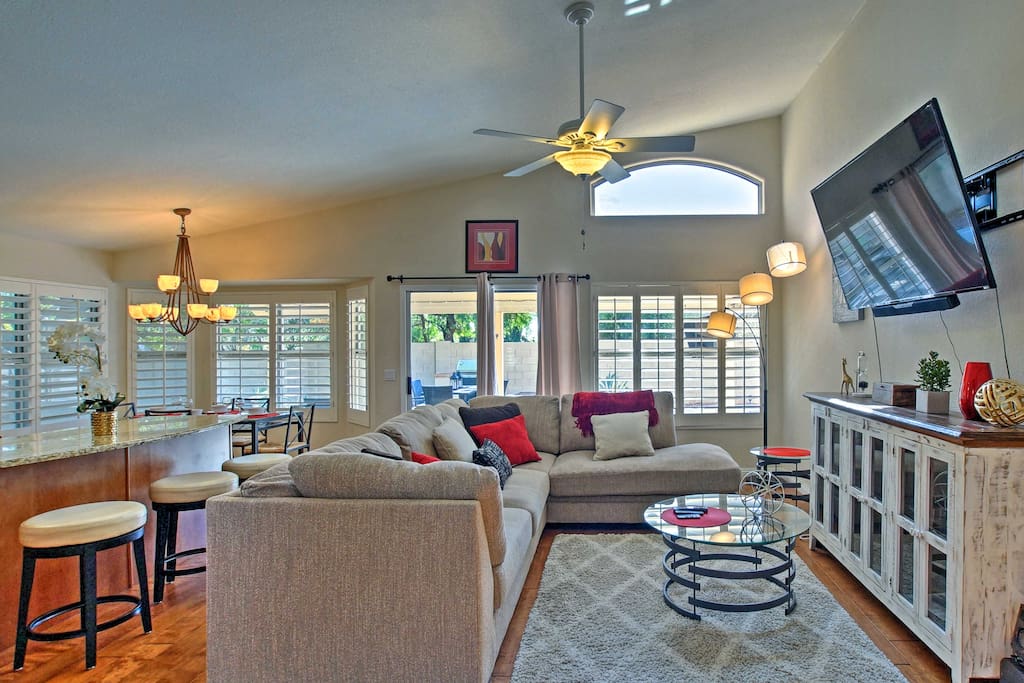 The bright and breezy living area offers a plush L-shaped sofa and flat-screen cable TV.