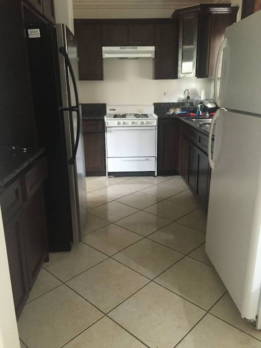 The kitchen w/ 2 Refrigerators.