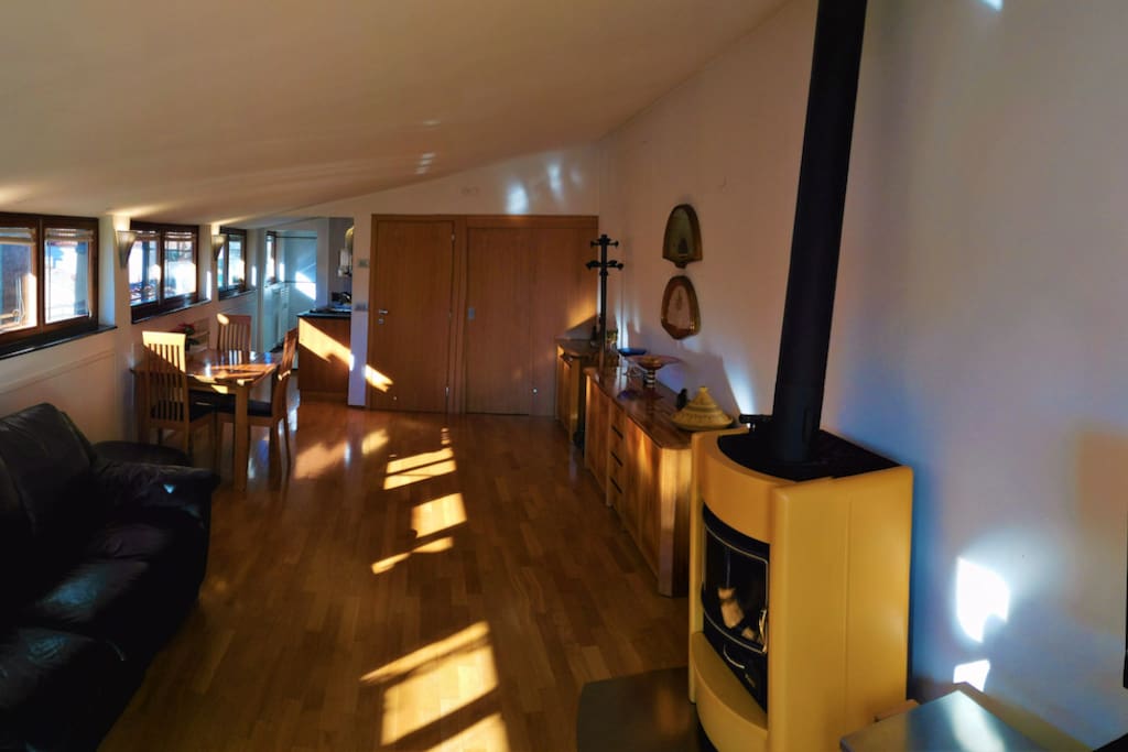 Sunlight pours in the many windows of this lovely rooftop flat.
