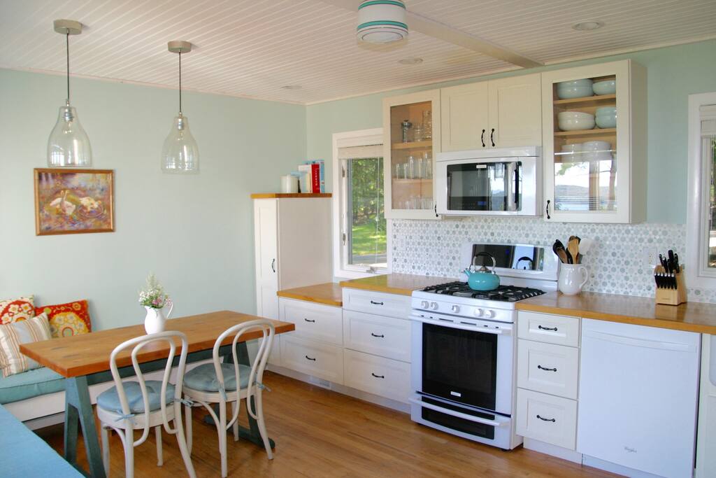 Bright, spacious well-stocked cook's kitchen.