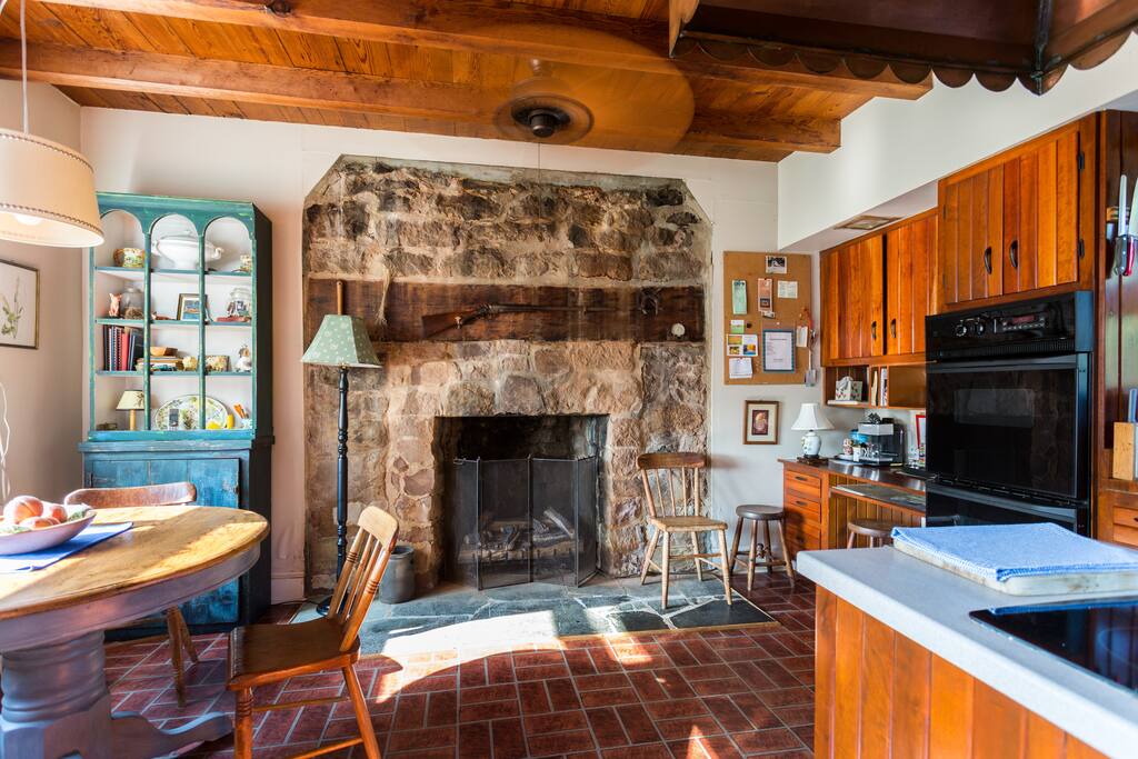 Kitchen fireplace has gas logs.