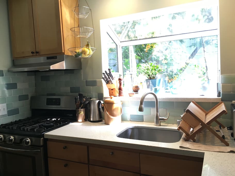 Kitchen has recycled glass backsplash and quartz countertops.