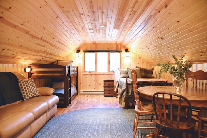 The loft above the garage is the perfect place for a family to have a private area to themselves. Queen bed, bunks, dining/game table, couch, tv, microwave, frig and microwave.