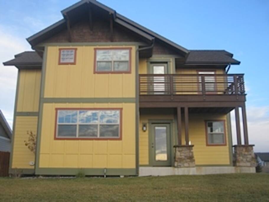 Rear of house showing deck & patio, leading to community trail and park