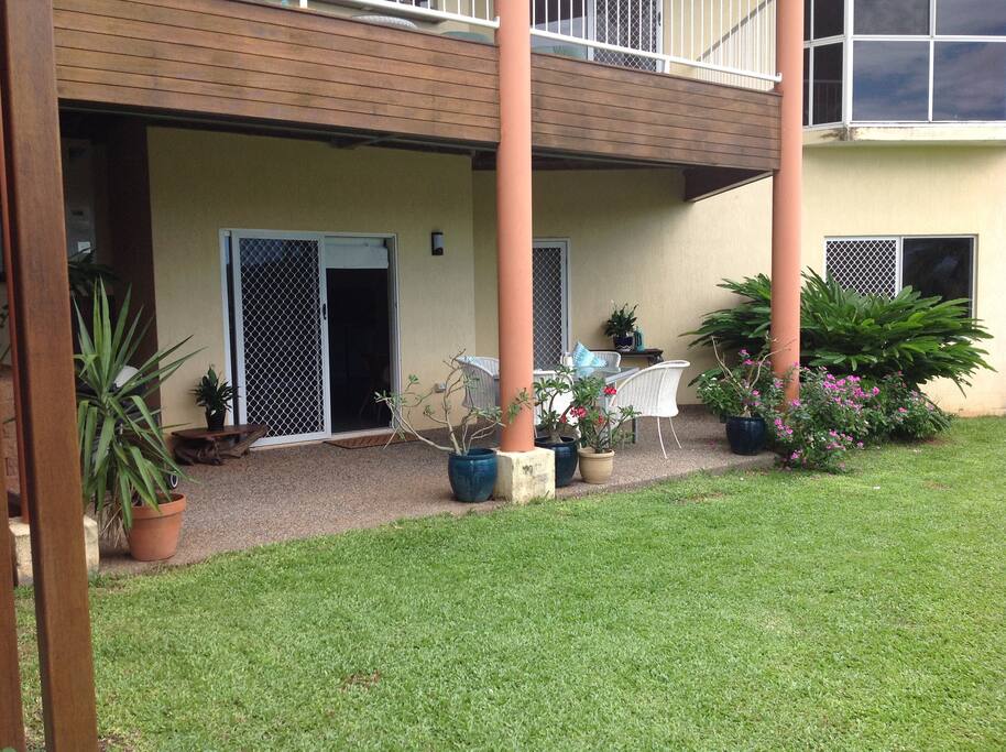 Sheltered outdoor dining with access to lush tropical garden and views.
