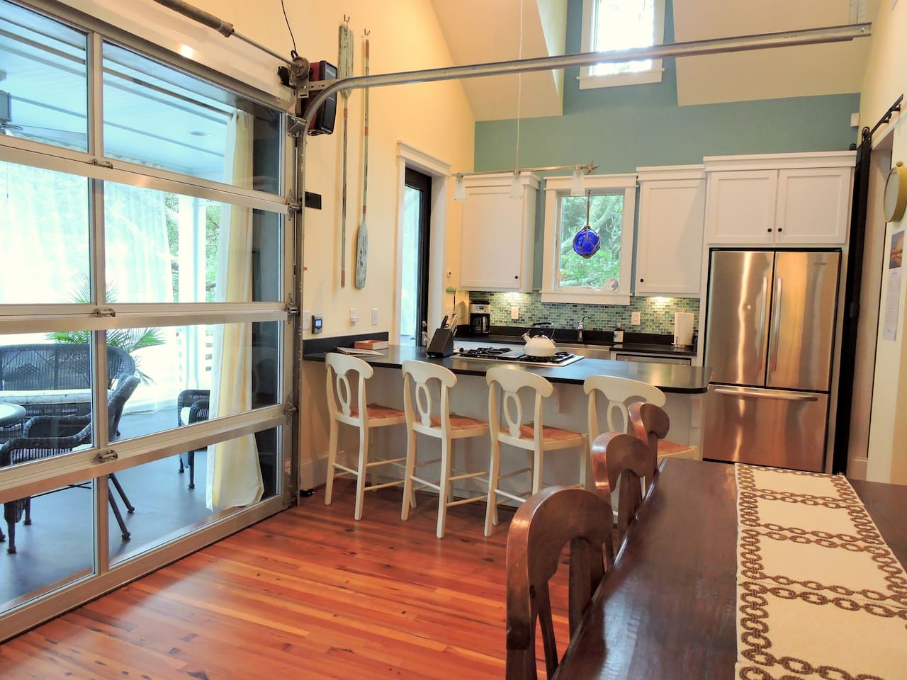 High end kitchen with dining room that opens to the porch through the garage doors