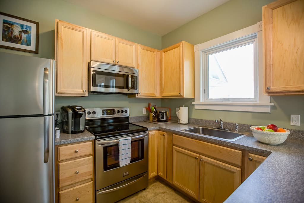 Enter into the large kitchen with all the amenities of home. Fiestaware dinnerware, large fridge, dishwasher, Keurig coffee maker (pods too!).
