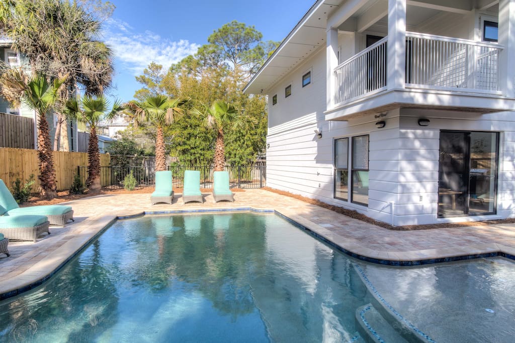 Large private pool with lounge seating on the deck and tanning ledge in the pool