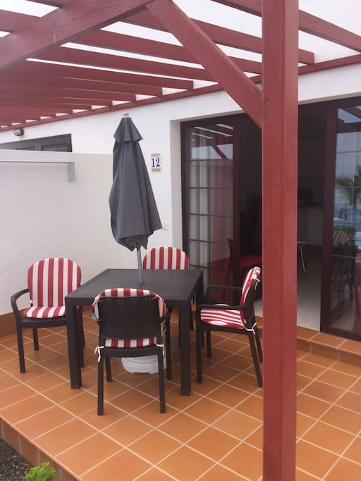 Outside patio area which receives the morning sun first thing in the morning, until around 4pm, complete with table and chairs for guests to relax. Parasol also provided, it does get rather hot.