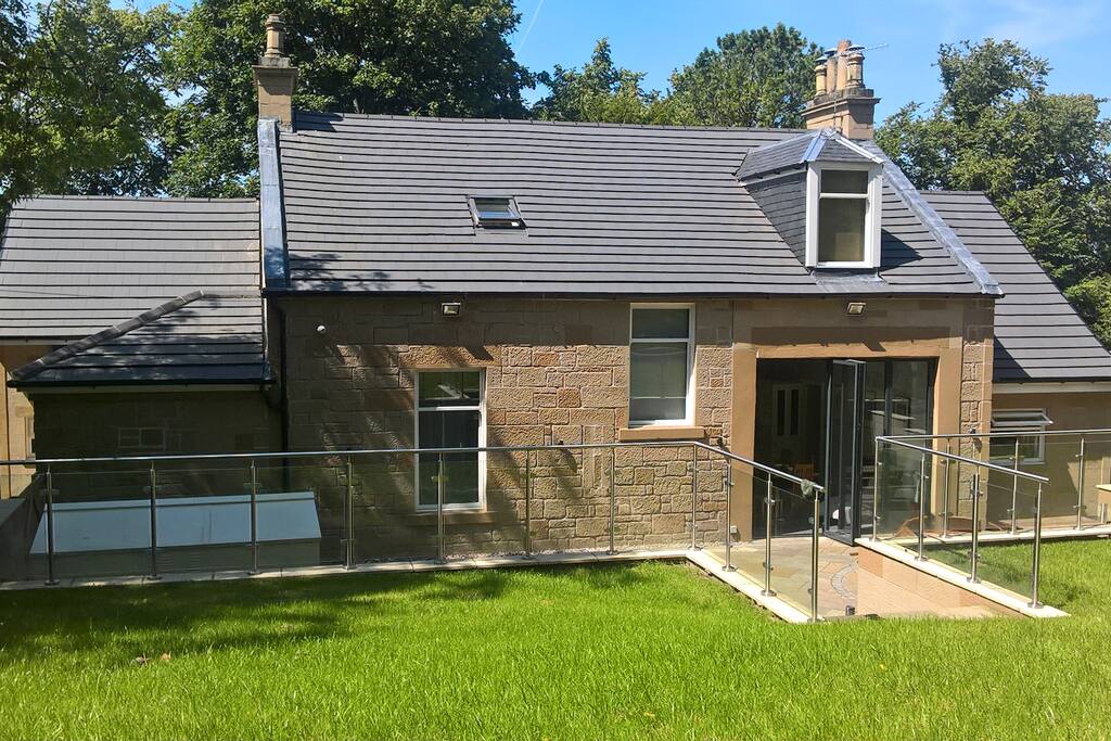 Rear view of house from garden, with ground floor guest bedroom window on left.
