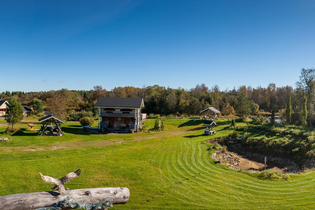 Our Backyard. You can see the stream behind the outside cabin. The stream will give you nice sleep at nights.