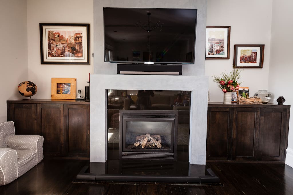 Open living room, with a 55" smart TV mounted over the fireplace