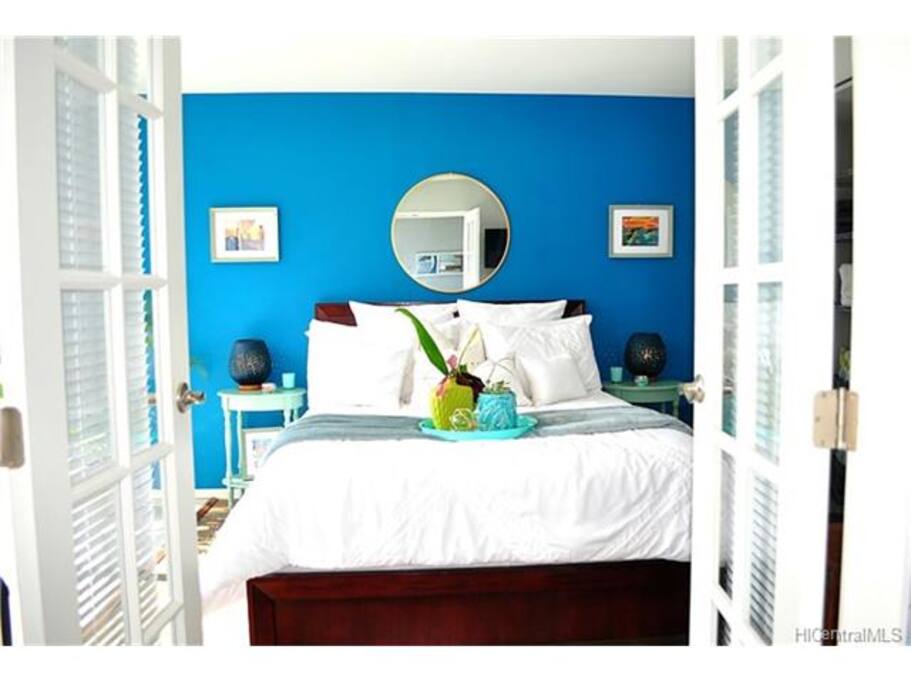 1st bedroom comes with two side tables, mirror, and tasteful décor. All linens, blankets, and pillows included.