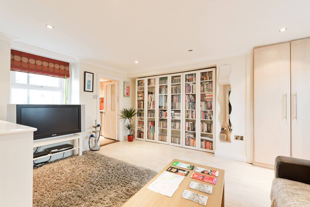 Sitting room showing bookcases and 32inch TV with satellite and Sky Sports