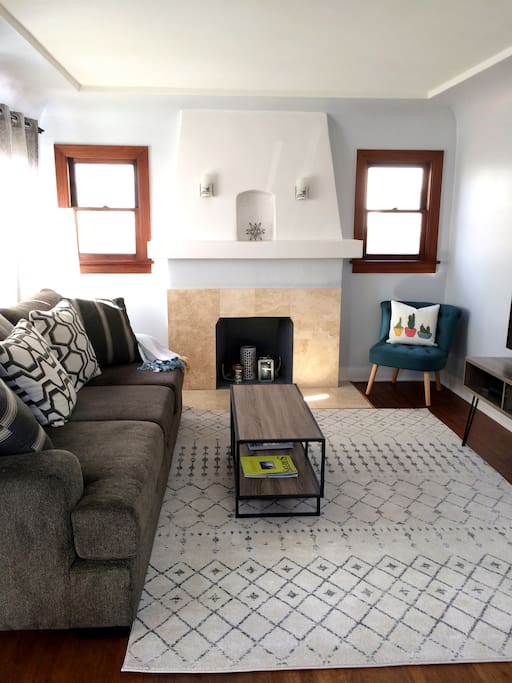 Beautiful Main Living area with coved ceiling, original fireplace and hardwood floors.