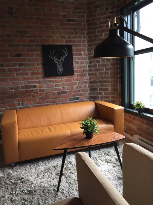 Living room with exposed, original brick.