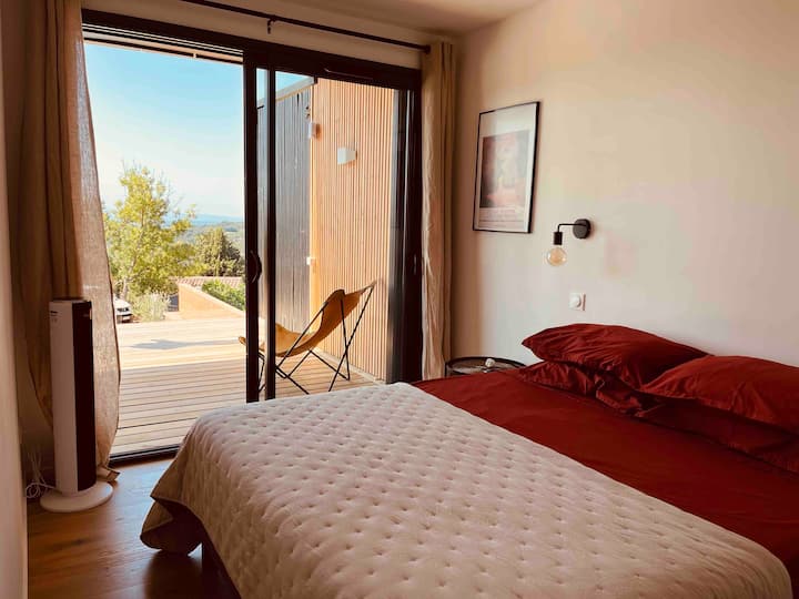 Bedroom 1. This is the slightly larger bedroom. A double bed (160cm wide). This is a twin bed so can be split to two 80cm singles. Room also has open wardrobe style storage. The room has double sliding doors opening on the 4 meter deep wood terrace.