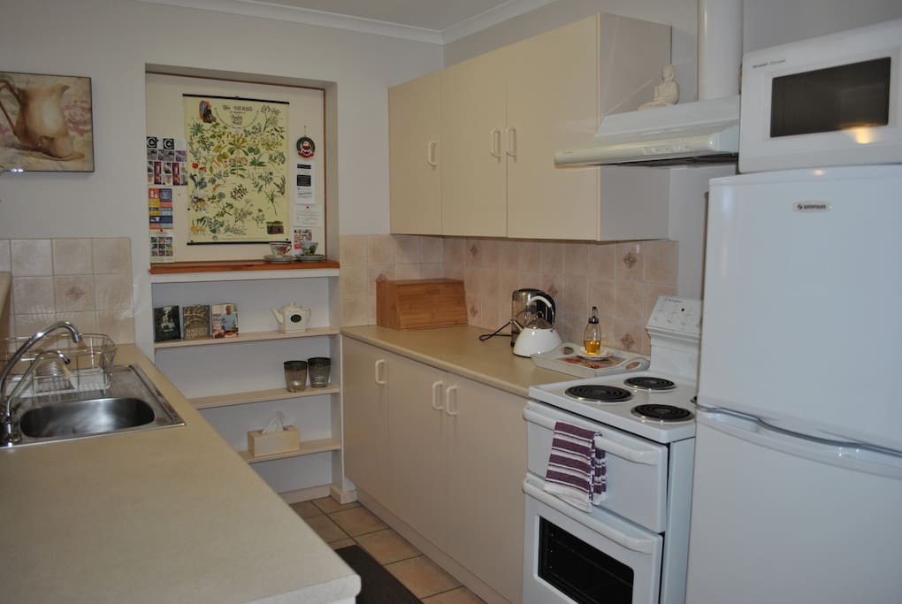 The compact kitchen area is ideal for making that morning coffee, plus well stocked cupboards for preparing gourmet meals.