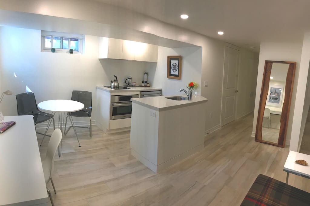 The full kitchen has a deep stainless sink and high efficiency appliances – fridge, stovetop, microwave and oven. Nearby, you'll love our tall, wood-crafted standing mirror.