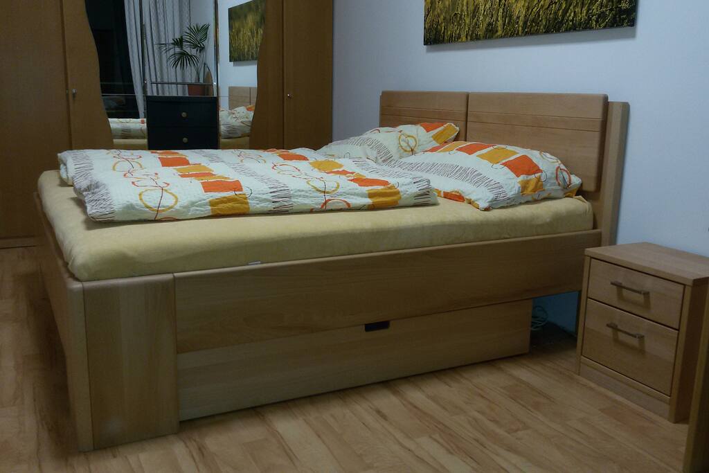 Very comfortable queens bed in bedroom from massive wood.