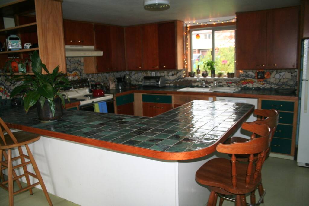 Here is our kitchen. Lots of counter space and cabinets. Our handmade tiles and decorative backsplash get lots of complements. Fortified with lots of handmade pottery.