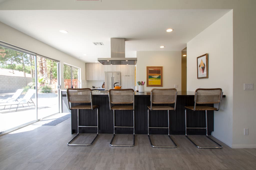 Mammoth island with counter stools that open to living room