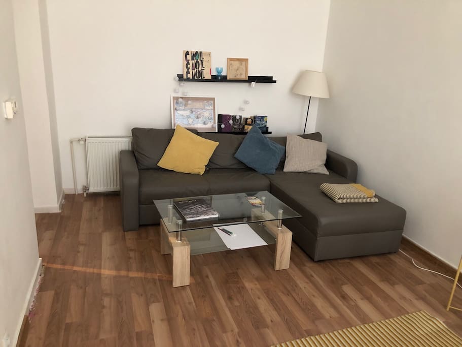 sofa in the living room which is in the rear corner and not visible on the main photo