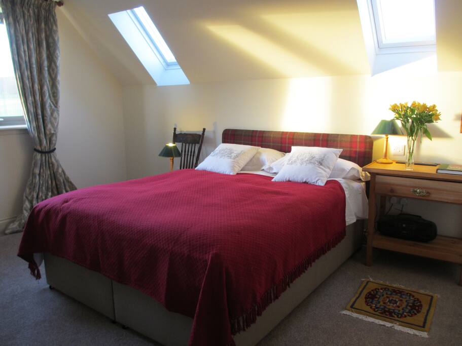 Double bedroom ensuite with additional single bed and west facing hill views