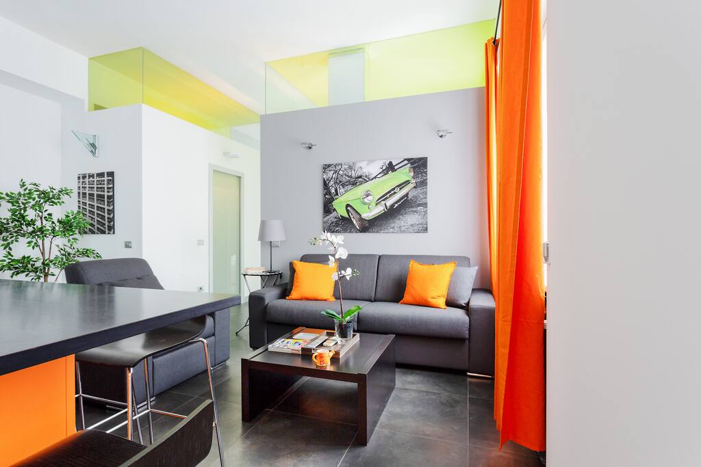The living room: sofa, dining table, TV, AC