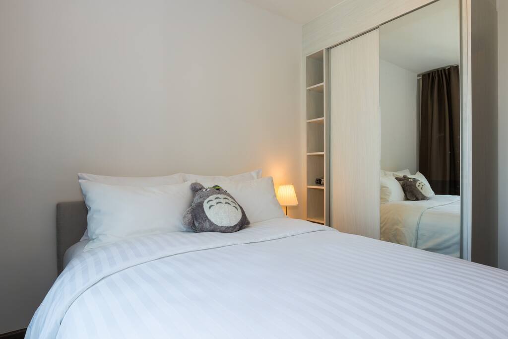 The bedroom closet is quite spacious and comes with hangers and a full body mirror.