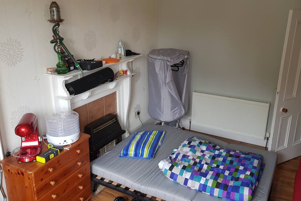 Bedroom with unfolded double bed.