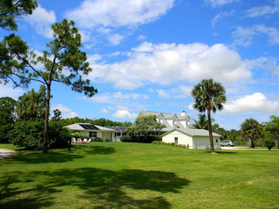 Guest House is on the far left with private driveway and entrance, pool in the middle, and main house on the far right. Fire pit located in front of the guest house.
