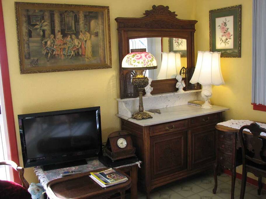 HD flat screen Dish TV, dresser, and desk area.