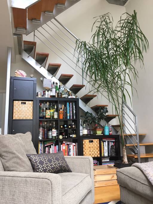 Double-height loft ceilings. Stairwell to mezzanine level and upwards to private roof.