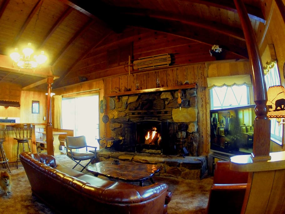 Living room with huge stone fireplace, 55' tv, pool table/air hockey/ping pong