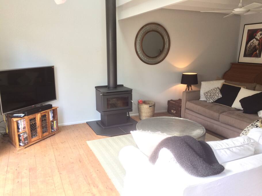 Cosy Living Area with High Ceilings and Flat Screen TV