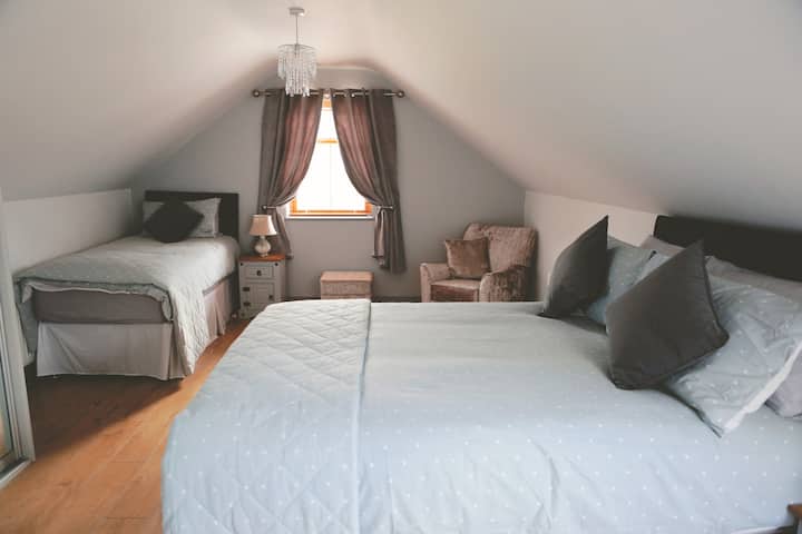 Spacious bedroom on 1st floor with double and single bed.
