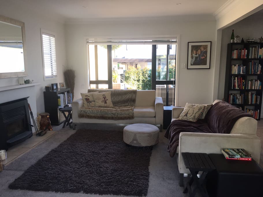 Comfortable, spacious main living room with outdoor flow to north and south facing decks and gardens.