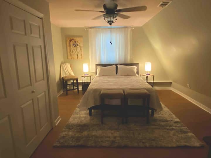 Downstairs bedroom with queen bed. Both bedrooms have new Spa Sensations by Zinus 12” Green Tea Memory Foam Mattress.  Not shown is a large dresser and large closet for extra storage. Both rooms have lamps with usb chargers. Beds are firm. 