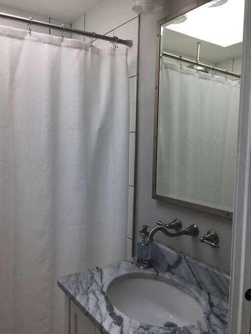 The amazing bathroom complete with a shower that has three faucets. All of them work at the same time!