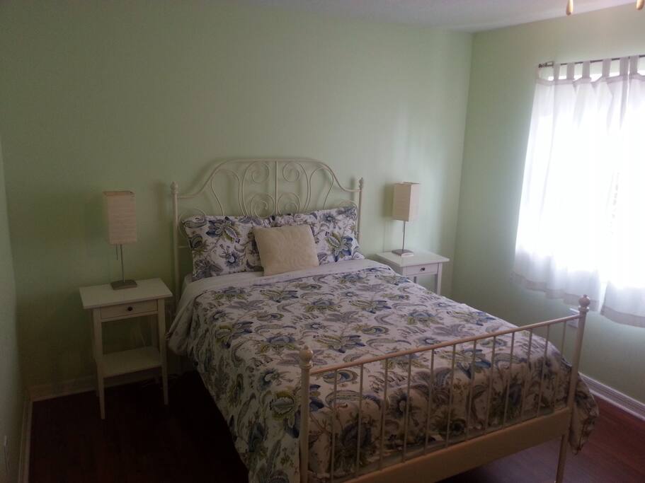 Cozy bedroom with a queen sized bed and extra futon