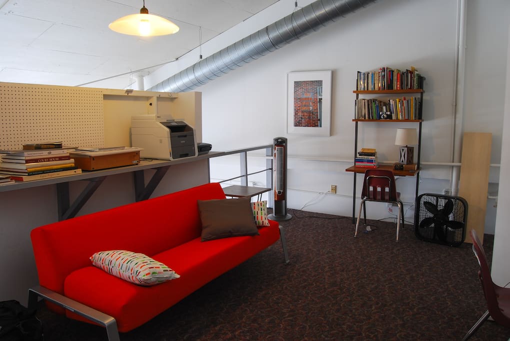 the upstairs living space of the loft with the couch in upright position. The space heater/fan is an incredibly effective way to supplement the central heat/ac on particular cold or warm nights