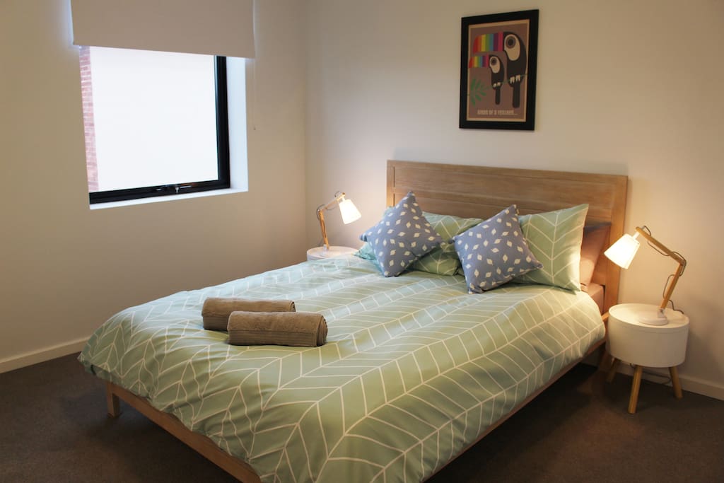 Master bedroom with queen size bed, blockout blinds and large wardrobe.